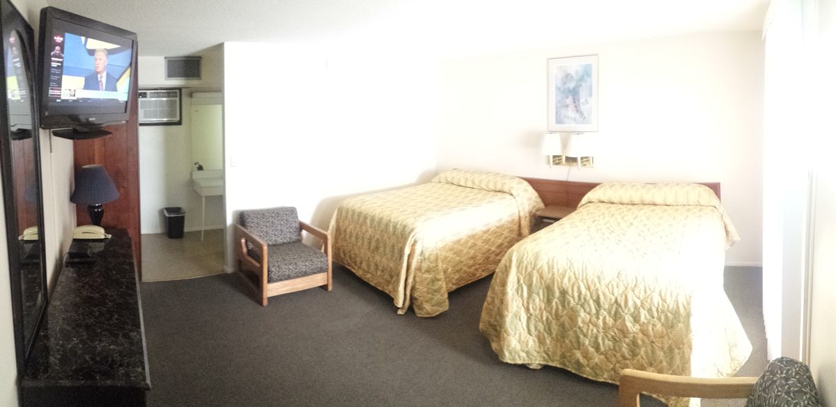 Guest room with two beds and seating